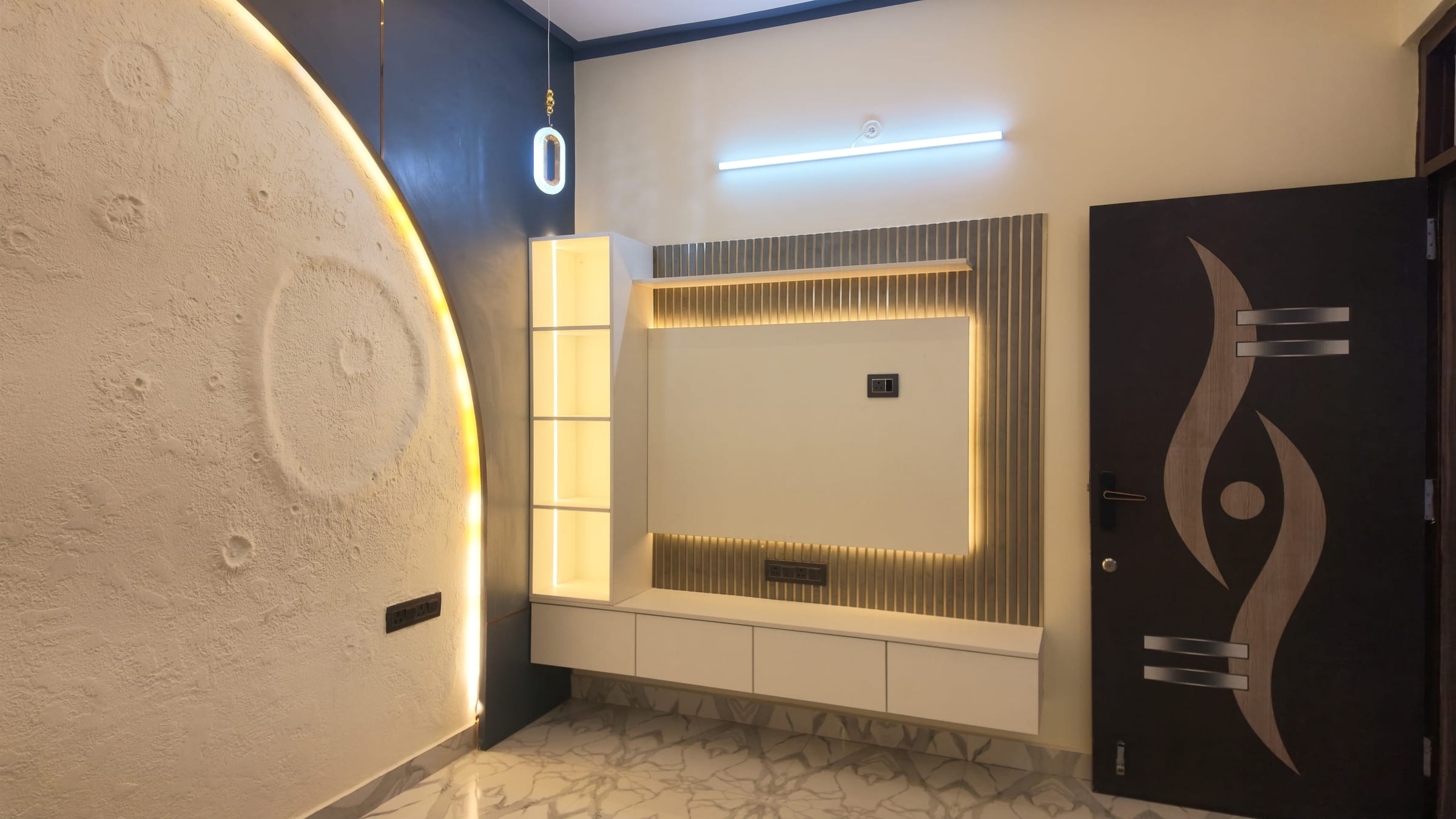 A television wall with a fluted panel behind the screen and a floating drawer unit below, beside a backlit arched feature wall